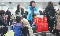  ?? FENG YONGBIN / CHINA DAILY ?? Passengers are stranded at Beijing Capital Internatio­nal Airport due to flight delays caused by heavy smog in December.