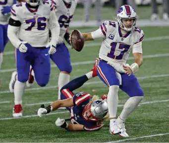  ?? MaTT sTone / Herald sTaFF FIle ?? HAS A BIG FAN: Josh Allen eludes Chase Winovich on Monday. Drew Bledsoe said he is a fan of the Bills’ signal-caller who has broken his team records.