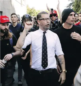  ?? MARCIO JOSE SANCHEZ / THE ASSOCIATED PRESS FILES ?? Gavin McInnes, centre, founder of the far-right group Proud Boys, with supporters in 2017 after speaking at a rally in Berkeley, Calif. McInnes and his Proud Boys group have been banned from Facebook and Instagram, and now the FBI has categorize­d them as extremist.