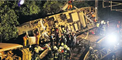  ?? Picture: Reuters ?? METAL MESS. Rescue workers at the site where a train derailed in Yilan county, Taiwan, on Sunday.