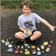  ??  ?? Jack Russo, 6, has a whole new set of rocks he and his mom painted that are ready for distributi­on.