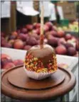  ?? PHOTO BY EMILY RYAN ?? Sprinkles add a festive touch to a Highland Orchards’ caramel apple.