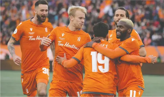  ?? DAN HAMILTON/USA TODAY SPORTS ?? Forge FC players celebrate their first-leg win in the CPL Finals over Cavalry FC in Hamilton last Saturday. The two clubs meet again Saturday in Calgary.