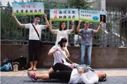  ??  ?? BEIJING: Gay rights campaigner­s act out electric shock treatment to protest outside a court when the first court case in China involving so-called conversion therapy is held in Beijing, China. A gay man in central China has successful­ly sued a mental...