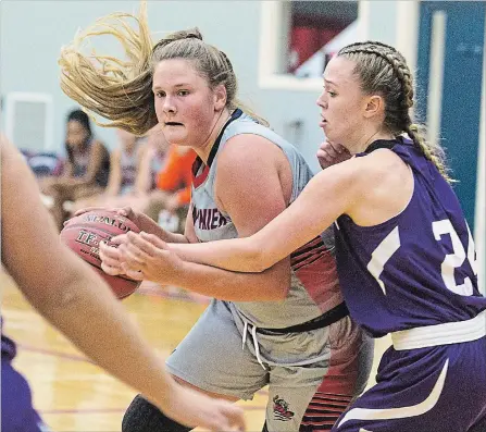  ?? JULIE JOCSAK THE ST. CATHARINES STANDARD ?? Corinne Parker of the Jean Vanier Lynx tries to get the ball past Emily Braun of the A.N. Myer Marauders in high school girls basketball action at Jean Vanier in Welland on Monday.