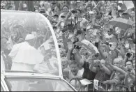  ?? AP/CZAREK SOKOLOWSKI ?? Pope Francis salutes the crowd Wednesday on his way to Wawel Castle in Krakow, Poland.