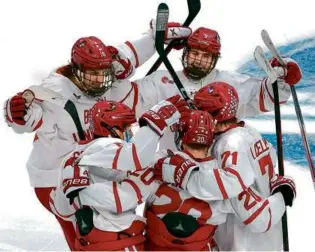  ?? BARRY CHIN/GLOBE STAFF ?? BU’s Quinn Hutson found himself at the center of the celebratio­n after putting the Terriers up, 2-0, in the second period against Maine.