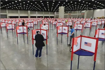  ?? The Associated Press ?? VOTING STATIONS: Voting stations are set up in the South Wing of the Kentucky Exposition Center for voters to cast their ballot in the Kentucky primary on June 23 in Louisville, Ky. Just over four months before Election Day, President Donald Trump is escalating his efforts to delegitimi­ze the upcoming presidenti­al election. Last week he made a startling, and unfounded, claim that 2020 will be “the most corrupt election in the history of our country.”