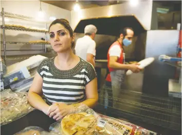  ?? JASON PAYNE ?? Shahnaz Oleh oversees the production of Persian specialtie­s at Amir Bakery in North Vancouver. There are often lineups when it opens at 6:30 a.m.