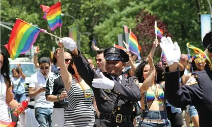  ?? Photograph: Julia Weeks/AP ?? An NYPD officer takes part in the 2014 Pride march. Organisers of the 2021 event have banned police participat­ion this year.