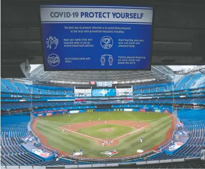  ?? — GETTY IMAGES FILES ?? A COVID-19 warning sign is seen over the diamond at Rogers Centre on July 9 in Toronto. With MLB teams allowing limited or no fans, fantasy leagues are taking off.
