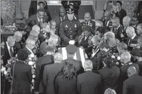  ?? The New York Times/ERIN SCHAFF ?? Members of the Congressio­nal Black Caucus pay their respects Thursday around the coffin of Rep. Elijah Cummings at a memorial service at the U.S. Capitol.