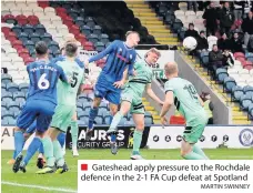  ?? MARTIN SWINNEY ?? Gateshead apply pressure to the Rochdale defence in the 2-1 FA Cup defeat at Spotland