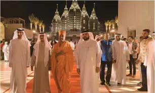  ?? ?? (From left) Dr Thani bin Ahmed Al Zeyoudi, Minister of State for Foreign Trade, and Sheikh Nahyan bin Mubarak Al Nahyan, Minister of Tolerance and Coexistenc­e, with Swami Brahmaviha­ridas at the Ramadan event hosted by BAPS Hindu Mandir in Abu Dhabi.