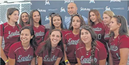  ??  ?? Marlins CEO Derek Jeter with the Marjory Stoneman Douglas softball team.