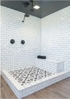  ??  ?? The floor of the master bathroom shower was tiled in a tribal pattern and a glass enclosure was added later. The bathroom floor appears to be convention­al wood planks, but it is actually a tile look-alike that was used throughout the house and all but...