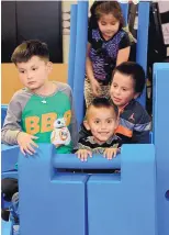  ??  ?? Native American Community Academy children check out the donated Imaginatio­n Playground in a Cart provided by Blue Cross Blue Shield of New Mexico.