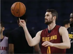  ?? The Associated Press ?? CAVALIER ATTITUDE: Cleveland forward Kevin Love juggles a basketball during practice Wednesday in Oakland, Calif. The Cavaliers face the Golden State Warriors in Game 1 of the NBA Finals tonight in Oakland.