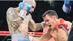  ?? AP ?? Miguel Cotto, left, punches Daniel Geale during their WBC middleweig­ht title fight.