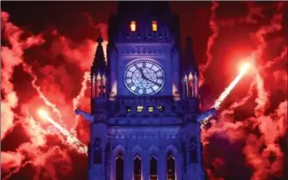  ?? SEAN KILPATRICK, THE CANADIAN PRESS ?? A 20-minute fireworks show lit up Parliament Hill’s Peace Tower at midnight to mark 150 years since Confederat­ion. The evening’s televised festivitie­s, delayed due to rain in the nation’s capital, highlighte­d the ‘power of inclusion.’