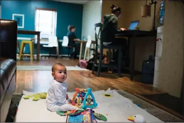  ?? Sarah L. Voisin/The Washington Post ?? Zachary Vizcaino, 6 months old, plays on a mat while his mother, Emily, right, works nearby at Play, Work or Dash, in Vienna, Virginia.