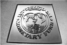  ??  ?? This file photo shows the logo outside the headquarte­rs of the Internatio­nal Monetary Fund in Washington, DC. A hollowing out of the middle class in advanced economies like the US, amid weak wage growth and rising inequality, is holding back global...