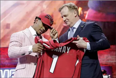  ?? AP/MARK HUMPHREY ?? Kyler Murray (left) is presented an Arizona Cardinals jersey and hat by NFL Commission­er Roger Goodell on Thursday night in Nashville, Tenn. Murray, the Heisman Trophy winner last season, was selected with the first pick of the NFL Draft by the Cardinals.