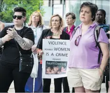  ?? ERROL McGIHON ?? People gather at the Human Rights Monument on Friday at a vigil for Elisabeth Salm and other victims of violence against women.