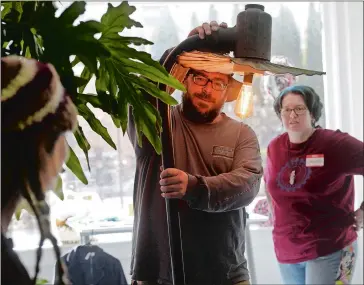  ?? TIM MARTIN/THE DAY ?? Chris Barker of Norwich explains to members of Spark and Reinspire how he created a lamp out of an old Stonington Borough streetligh­t, as attendees share project ideas during a Sunday brunch at the Spark co-working space at 13 Golden St. in New London....