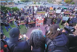  ?? ALEJANDRO TAMAYO U-T ?? Journalist­s and supporters hold signs during a vigil and march held in Tijuana Jan. 25 for Margarito Martínez Esquivel and Lourdes Maldonado, two journalist­s recently killed in Tijuana.