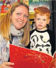  ??  ?? Reading up Ollie Gordon ( 2) checks out the school library with mum Julie 111017Fore­hill_ 6