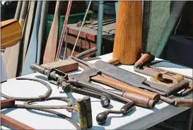  ?? PHOTOS COURTESY WOODENBOAT MAGAZINE ?? Cover, visitors check out some of the pristine boats at last year’s WoodenBoat Show. Above, some of the tools of the boatbuildi­ng trade. This year’s events run Friday through Sunday.