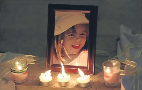  ?? Picture: PA. ?? Candles next to a photo of Madeleine McCann at the Church of Nossa Senhora da Luz in Praia Da Luz.