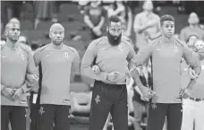  ?? ERIK WILLIAMS, USA TODAY SPORTS ?? Rockets players locked arms during the national anthem before a preseason game Oct. 5.