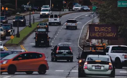  ?? PHOTOS BY SHMUEL THALER — SANTA CRUZ SENTINEL ?? A sign along Graham Hill Road in Felton alerts motorists that evacuation orders were in place Tuesday afternoon in advance of the coming storm.