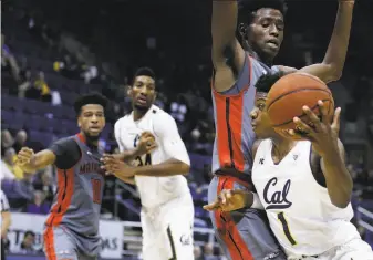  ?? Ben Margot / Associated Press ?? Cal guard Darius McNeill (right) drives around Cal State Northridge’s Micheal Warren during the first half of the Bears’ win. McNeill hit 6 of 7 three-point shots and scored 22 points.