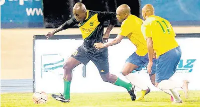  ?? FILE ?? Jamaican football icon Walter ‘Blacka Pearl’ Boyd carries the ball away from two Brazilian players during an exhibition match between Jamaica All Stars and Brazil All Stars at the National Stadium on Friday, March 3, 2017.