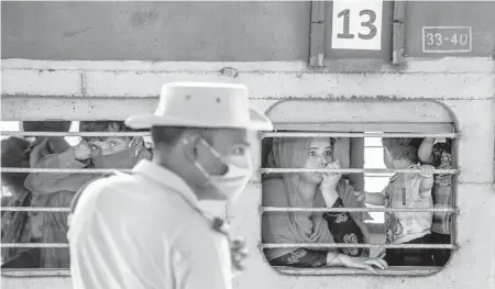  ??  ?? Migrant workers and their families in a crowded train during May in Mumbai. It has become clear that special trains operated by the government to ease suffering instead played a significan­t role in spreading the coronaviru­s into almost every corner of the country.