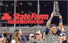  ?? Brett davis/ \uSa Today Sports ?? Atlanta Braves left fielder Eddie Rosario (8) celebrates withe NLCS MVP trophy after the Atlanta Braves beat the Los Angeles Dodgers in game six of the 2021 NLCS to advance to the World Series at Truist Park.