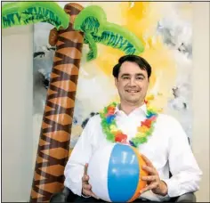  ?? (Arkansas Democrat-Gazette/Cary Jenkins) ?? Josh Hallenbeck, a board member and volunteer for Junior Achievemen­t, broke out a lei and beach ball in advance of the organizati­on’s Beach Bowl fundraiser. The event is 12 to 2 p.m. Friday at Millennium Bowl in Maumelle.