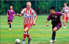  ?? PROVIDED TO CHINA DAILY ?? Players from Serbia’s Red Star Belgrade compete against a united team of local youngsters at an under-14 soccer tournament in Shenyang, Liaoning province, last August.