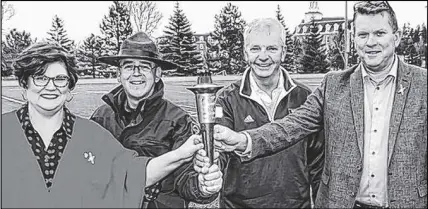  ?? COREY LEBLANC/SALTWIRE NETWORK ?? Special Olympics Canada 2018 Summer Games opening and closing ceremonies chair Mary Farrell, left, and John Pellerin of the Law Enforcemen­t Torch Run, along with Games’ co-chairs Carl Chisholm and Marc Champoux, hold the torch after the opening of the...