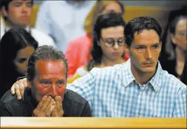  ?? RJ Sangosti ?? The Associated Press Frank Rzucek Jr. consoles his father, Frank Rzuceck Sr., at Tuesday’s arraignmen­t of Christophe­r Watts in the killing of Watts’ wife, two daughters and their unborn child.