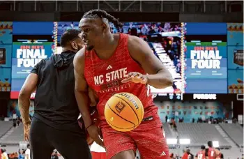  ?? Christian Petersen/getty Images ?? North Carolina State’s DJ Burns Jr. drives to the basket during a practice session at State Farm Stadium on Friday in Glendale, Ariz.