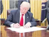  ?? AFP PHOTO ?? IT BEGINS
US President Donald Trump signs an executive order starting the process of undoing his predecesso­r’s signature health care scheme.