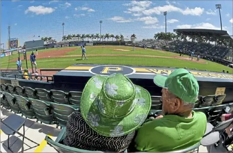  ?? Matt Freed/Post-Gazette ?? Fans take in a St. Patrick’s Day spring training game between the Pirates and the Tampa Bay Rays on Wednesday at LECOM Park in Bradenton, Fla.