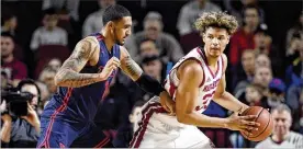  ?? AP ?? UMass freshman Tre Mitchell, here checked by Obi Toppin, gave the Dayton Flyers all they could handle Saturday with 26 points and 10 rebounds in 32 minutes.