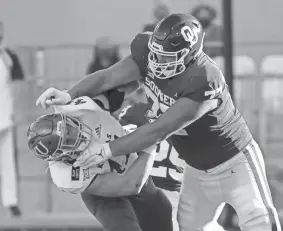  ?? KEVIN JAIRAJ/USA TODAY SPORTS ?? OU offensive lineman Erik Swenson (77) blocks Kansas linebacker Nick Channel during the first half of last year’s matchup in Norman. Swenson, a redshirt senior, is making an impact this season.