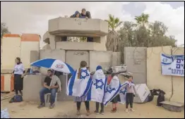  ?? ASSOCIATED PRESS ?? People gather Tuesday at Israel’s Nitzana border crossing with Egypt, protesting against the delivery of humanitari­an aid to the Gaza Strip until all hostages held by Hamas militants are released.