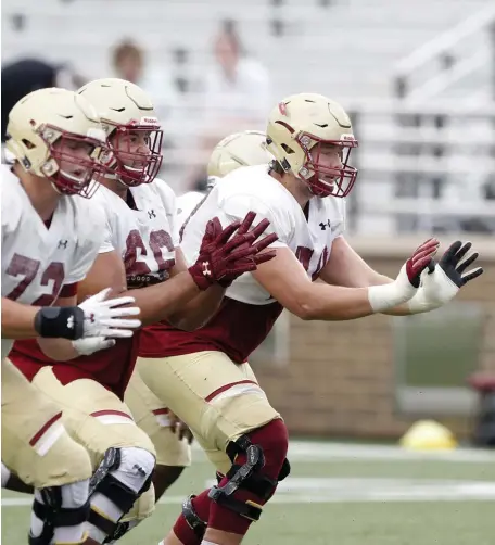  ?? BoSton HeraLd FILe ?? OUT IN FRONT: BC center Alec Lindstrom (right) pass block during a preseason scrimmage last year.